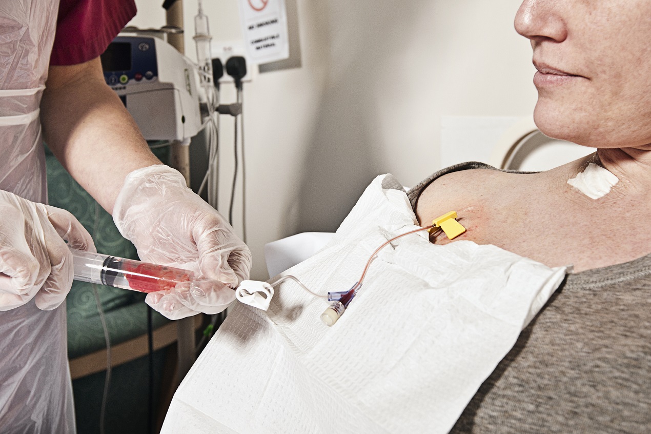 Nurse Flushing Central Line Before Administering Chemotherapy Treatment